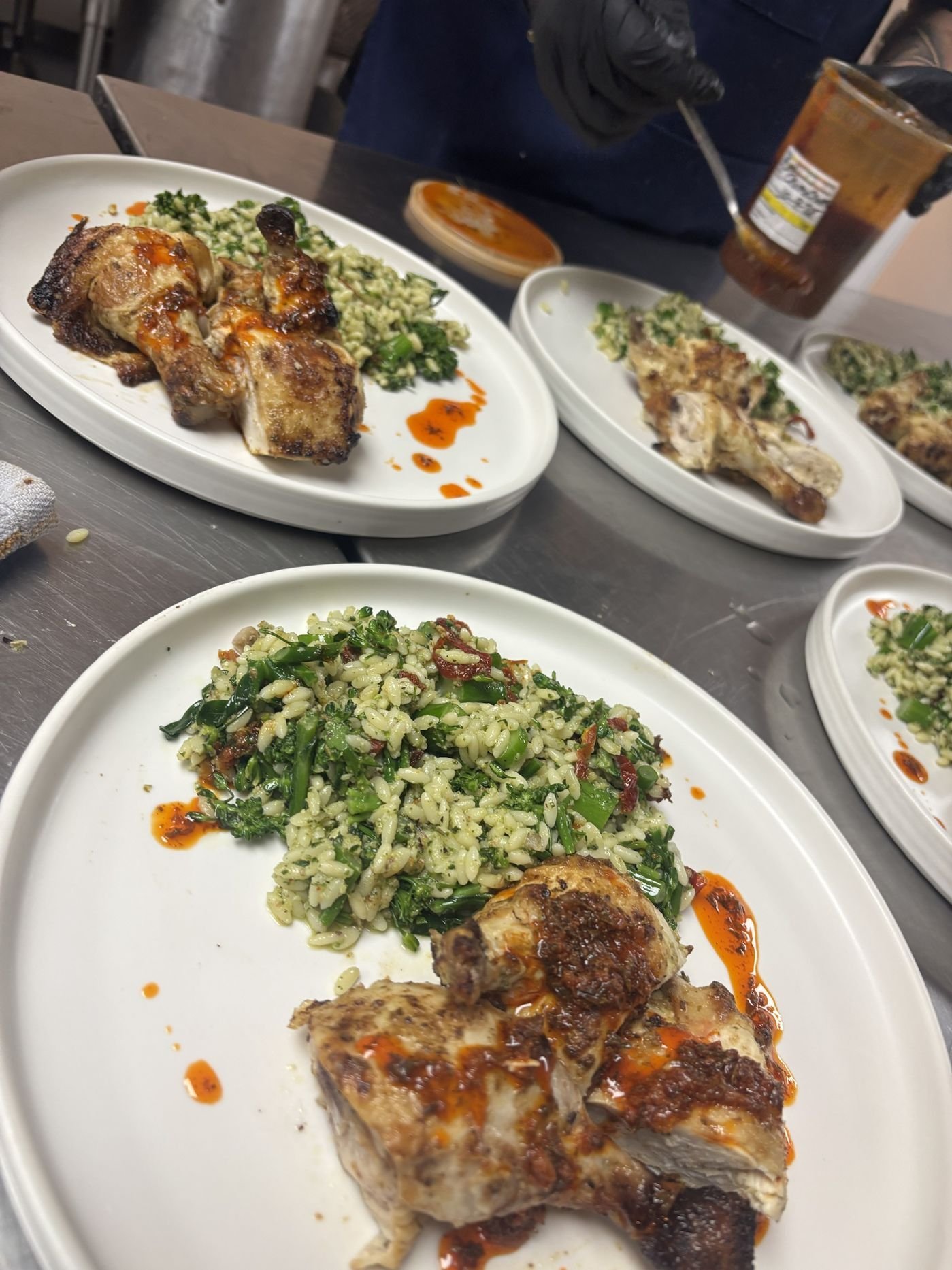 Roasted chicken over herbed orzo and broccolini finished with chili sauce